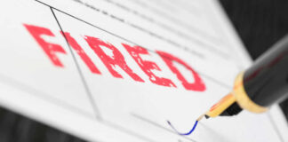 Fountain pen signing document with the word fired