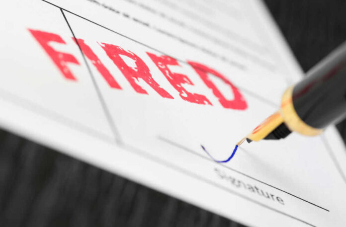 Fountain pen signing document with the word fired