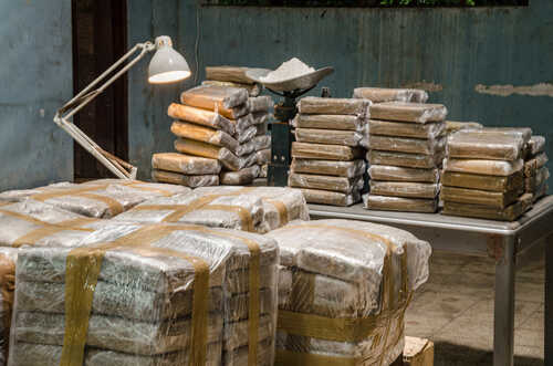 Stacks of wrapped packages in a dimly lit warehouse