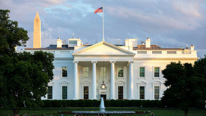 shutterstock_1819595129.jpg The White House with Washington Monument in background.
