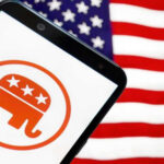 Smartphone with Republican Party logo, American flag background.