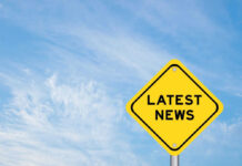 Yellow sign with text Latest News on sky background