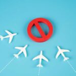 VIDEO: Senator’s Explosive Travel Alert A red prohibition sign surrounded by white airplane models on a blue background