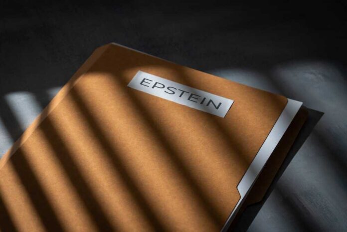 shutterstock_2738398427.jpg A brown folder with the name 'EPSTEIN' on it, partially illuminated by light and casting shadows