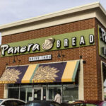 Exterior view of a Panera Bread restaurant with a drive-thru