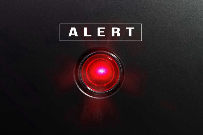 shutterstock_582441490.jpg Red alert light against black background, text ALERT.