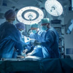 Doctors performing surgery in a modern operating room.