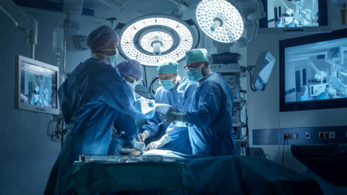 Doctors performing surgery in a modern operating room.