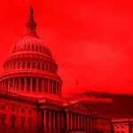 United States Capitol building under red-tinted sky.