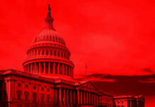United States Capitol building under red-tinted sky.