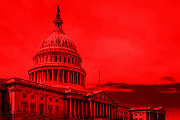 shutterstock_1142146865.jpg United States Capitol building under red-tinted sky.