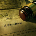 Gavel and Constitution with 1st Amendment text.
