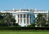 The White House, front view with fountain and flag.