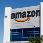 Exterior view of an Amazon building with a prominent logo