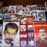 A display of various Joseph Stalin memorabilia including photographs, puzzles, and souvenirs
