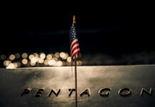 Pentagon Denies Explosive Report – But Who’s Lying? American flag above engraved Pentagon sign at night
