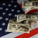 Dollar bills arranged on an American flag