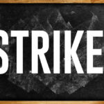 Chalkboard with the word 'STRIKE' written in bold white letters