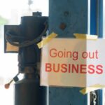 Iconic Tool Giant SHUTTING DOWN Legacy Plant Sign stating 'Going out of Business' attached to a pole