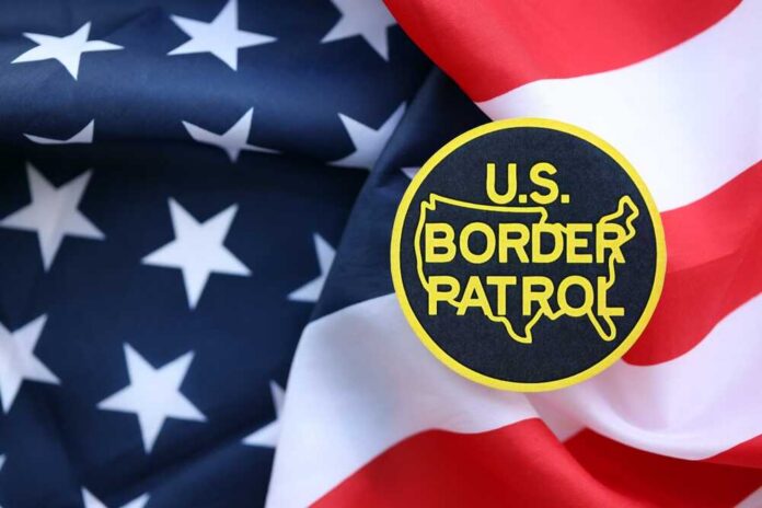 U.S. Border Patrol badge on a background of the American flag