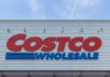 Costco Wholesale store sign against a blue sky