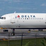 A Delta Airlines airplane on the runway at an airport