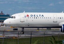 A Delta Airlines airplane on the runway at an airport
