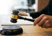 Gavel in judges hand about to strike.