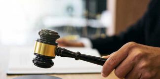 Gavel in judges hand about to strike.