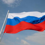 Russian flag waving against a cloudy sky.