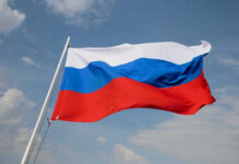 Russian flag waving against a cloudy sky.