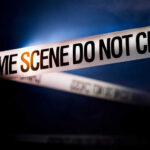 Cruise Liner Discovers FIVE DEAD BODIES Police tape reading 'CRIME SCENE DO NOT CROSS' in a dark setting