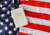 Bible on an American flag background.