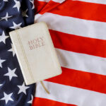 Bible on an American flag background.