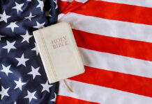 Bible on an American flag background.