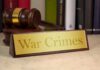 War Crimes Accusation Hits White House A wooden gavel next to a nameplate reading 'War Crimes'