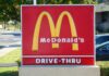 McDonald's drive-thru sign with iconic golden arches