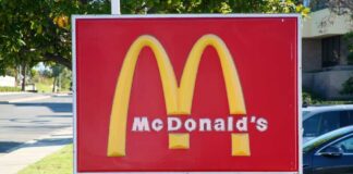 McDonald's drive-thru sign with iconic golden arches