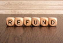 Wooden blocks spelling refund on table