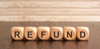 Wooden blocks spelling refund on table