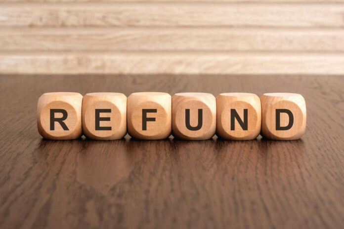Wooden blocks spelling refund on table