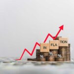 Graph showing inflation trend with coins and wooden blocks