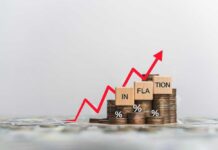 Graph showing inflation trend with coins and wooden blocks