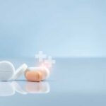 Assorted pills on a reflective surface against a light background