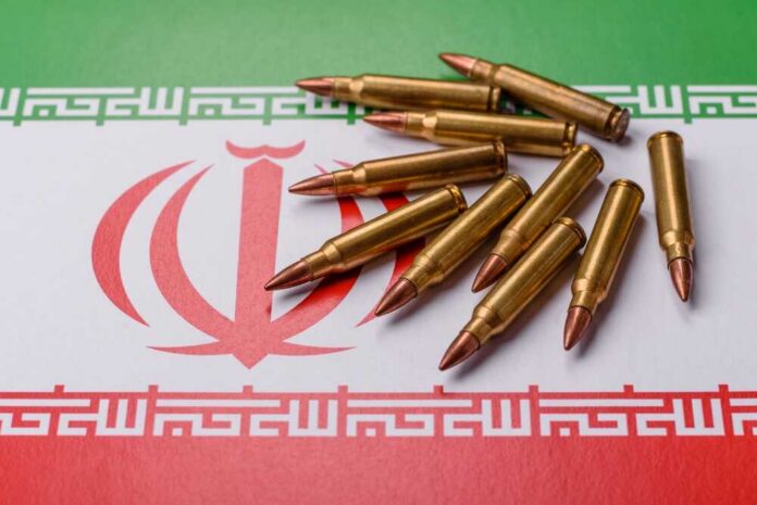 A collection of bullets resting on the Iranian flag
