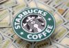 Starbucks coffee logo placed on a background of hundred dollar bills
