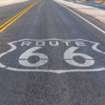 Route 66 highway sign painted on asphalt