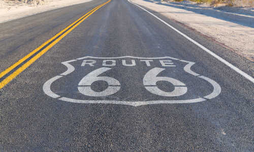 Route 66 highway sign painted on asphalt