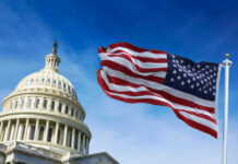 U.S. Capitol building with American flag waving.
