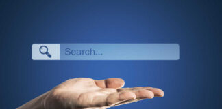 A hand holding an invisible search bar with a magnifying glass icon